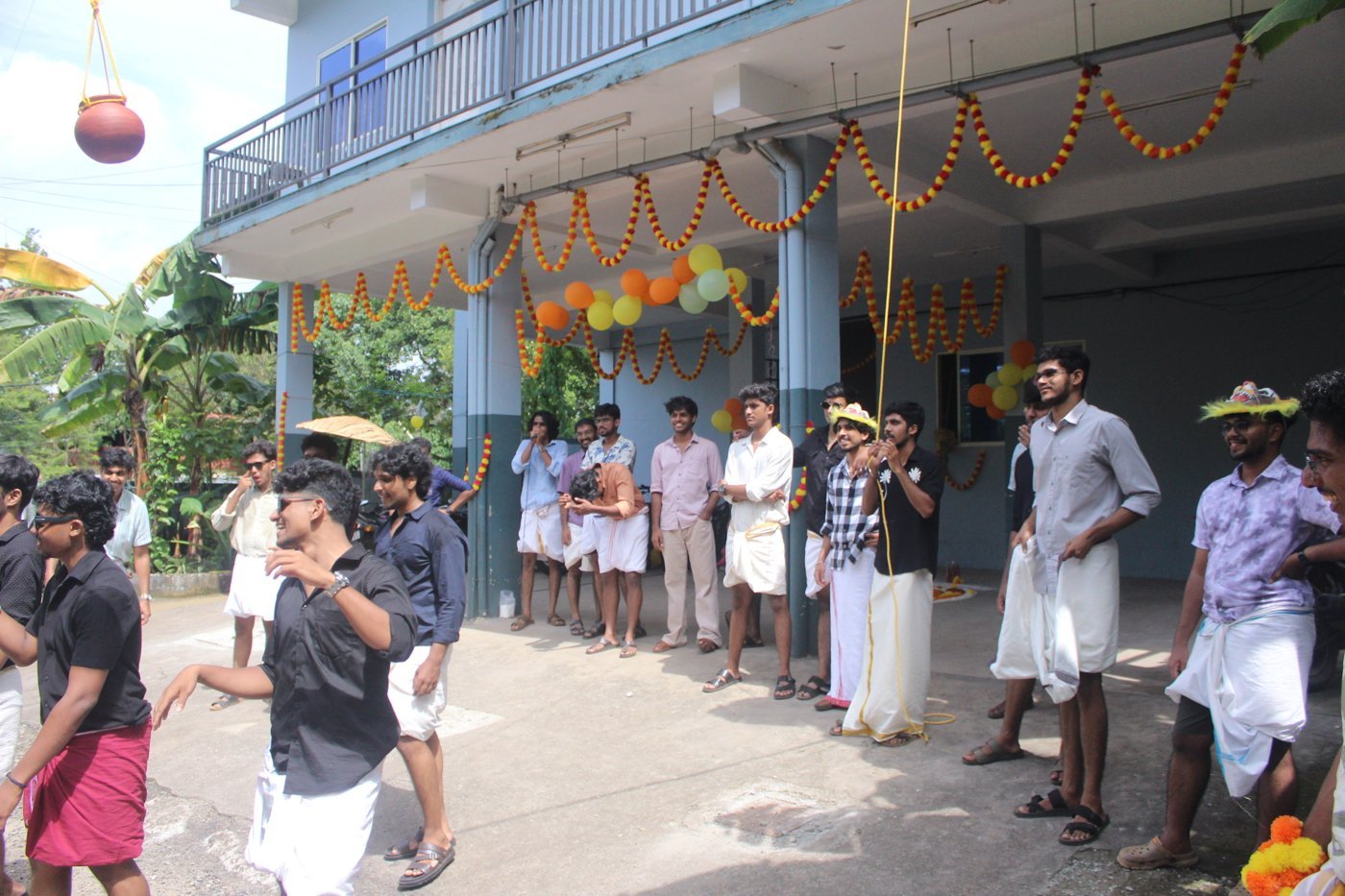 Ashiana Hostel residents gathered for Onam games under festive marigold garlands