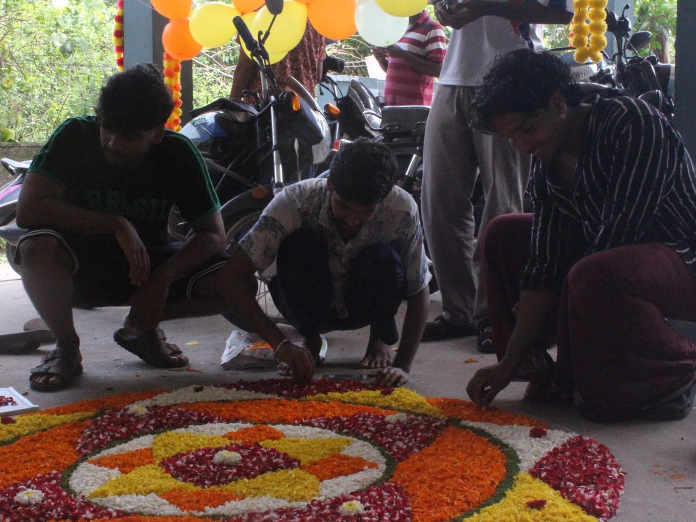 Ashiana Hostel residents laying the pookalam with flower petals for Onam 2026