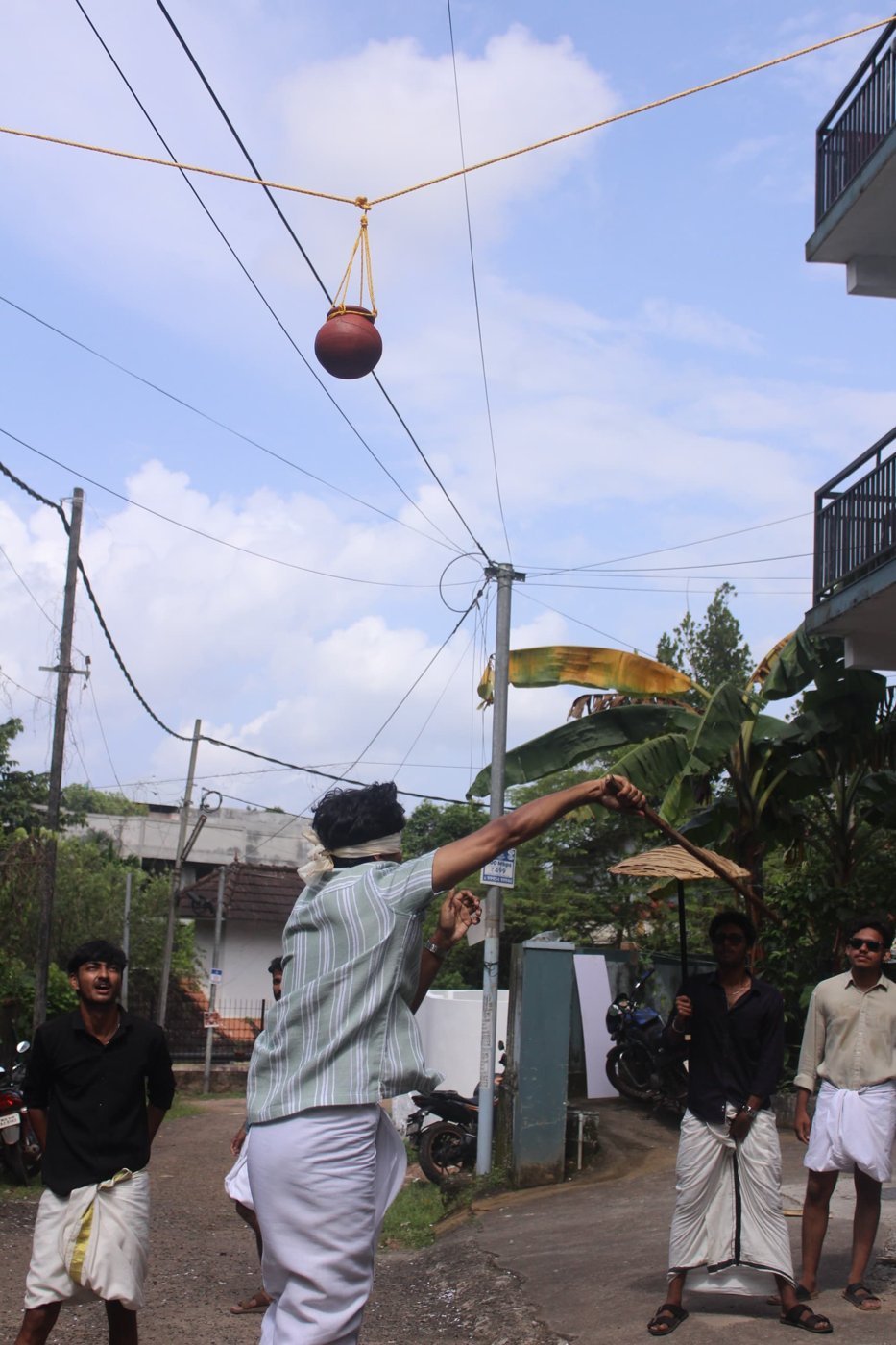 A blindfolded resident playing the traditional Onam pot-breaking game uriyadi at Ashiana Hostel